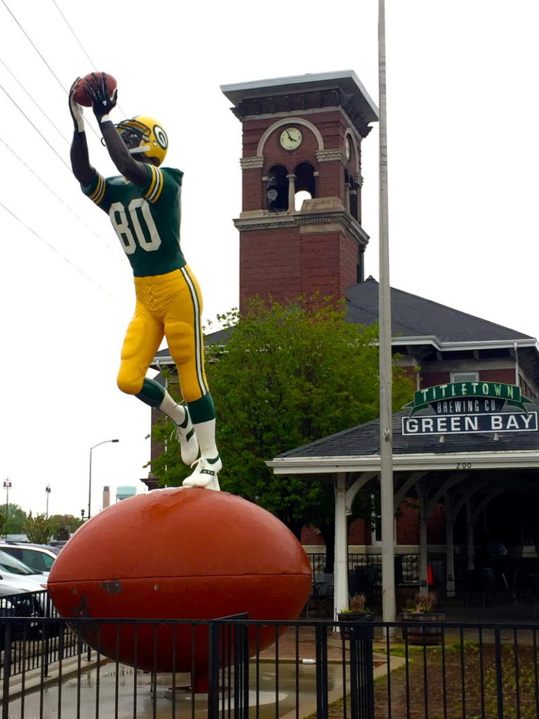 Green Bay Packers statue in front of Titletown Brewing Company, Geen Bay, Wiconsin Photo Credit: Tom Wilmer